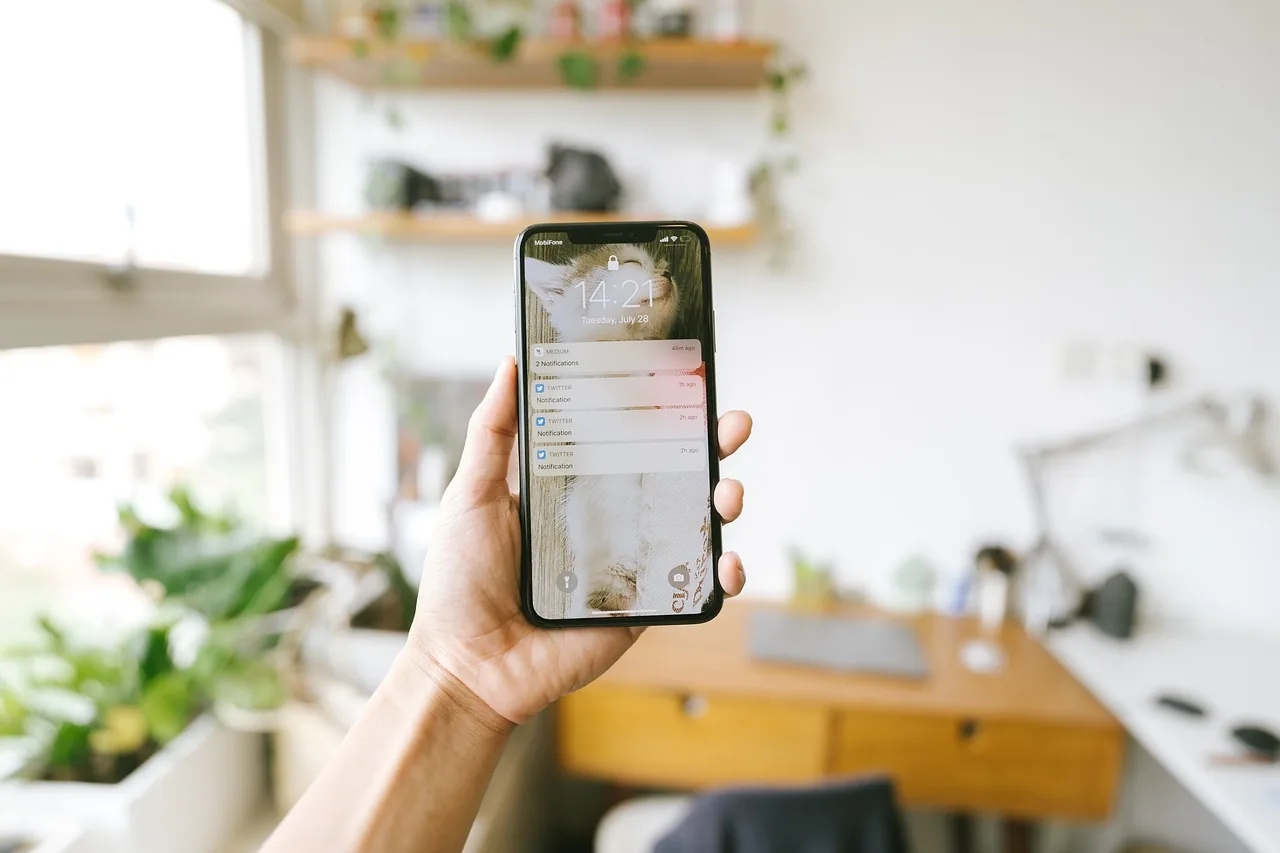 Person checking notifications on a phone at home